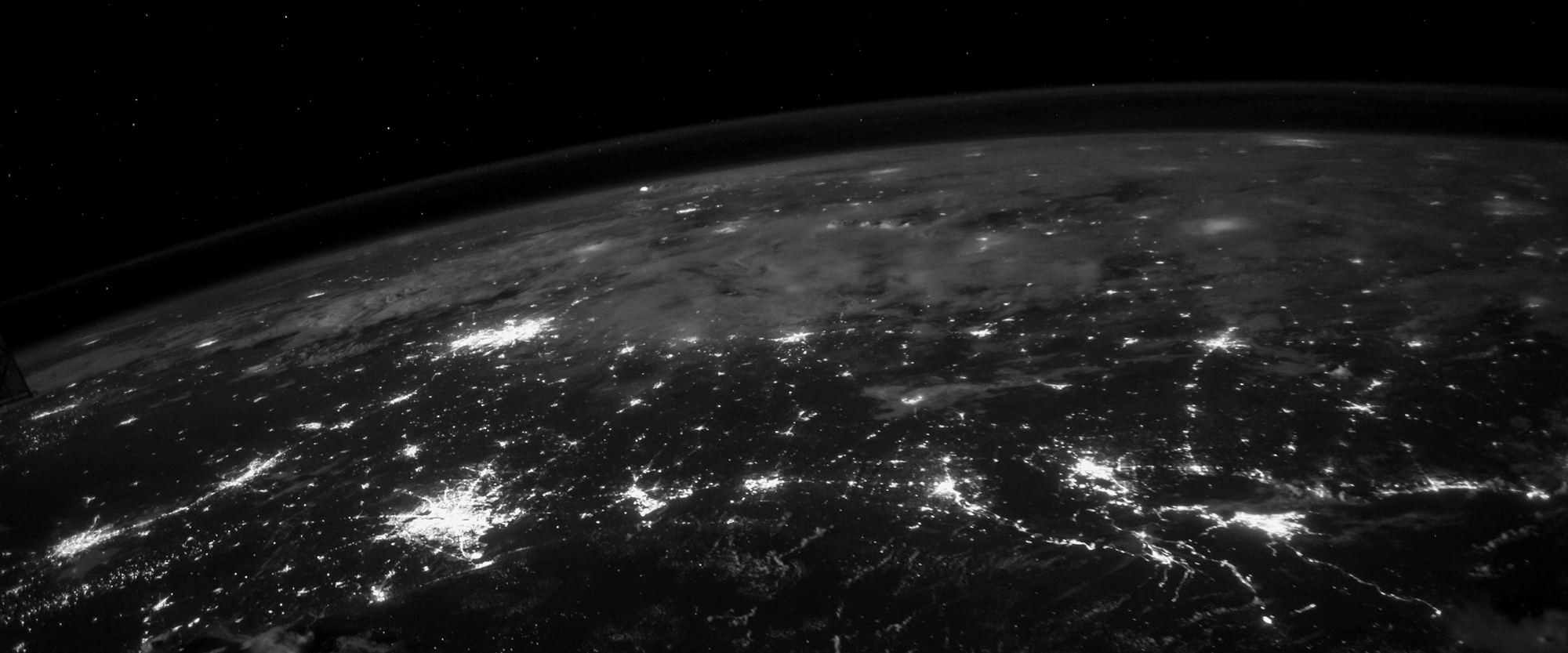 The earth at night, cities picked out as points of light.